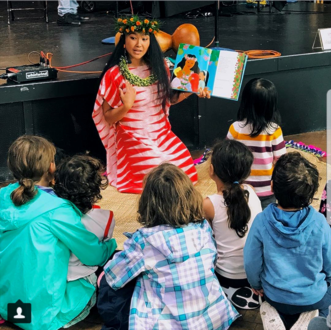 Picture Kalei'okalani of Huraiti Mana takes a break from hula dancing during her workshop at the Seattle Children's Festival to share the Story of Hula by Carla Golembe